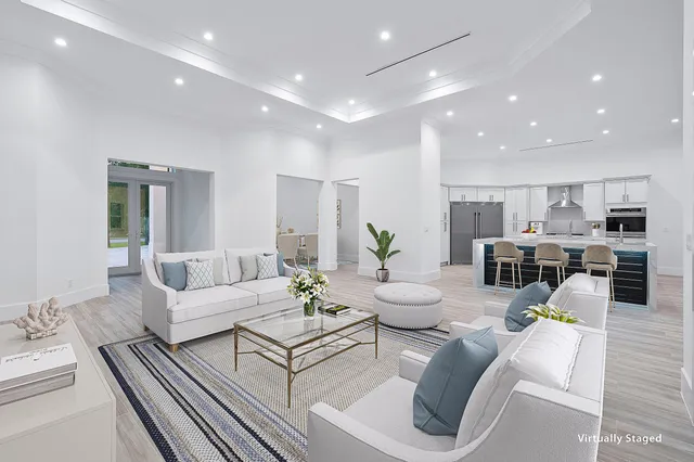 an empty room with wooden floor and natural light