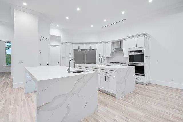 a kitchen with stainless steel appliances a refrigerator and a stove