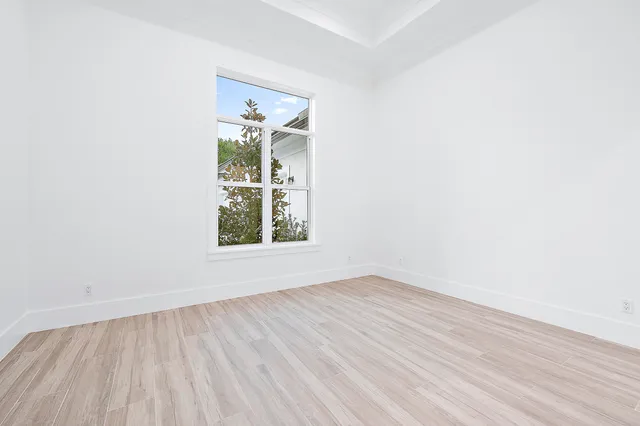 an aerial view of residential house with outdoor space and trees all around