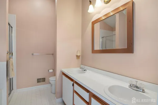 a bathroom with a sink a toilet and mirror