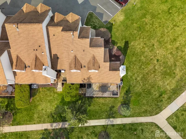 an aerial view of a house with a yard