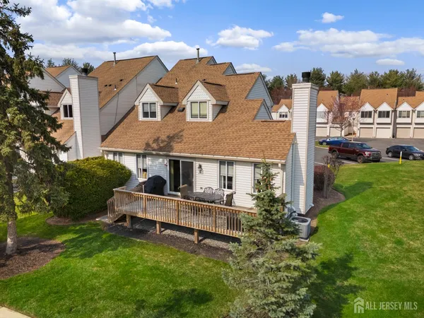 aerial view of a house with a big yard and large trees
