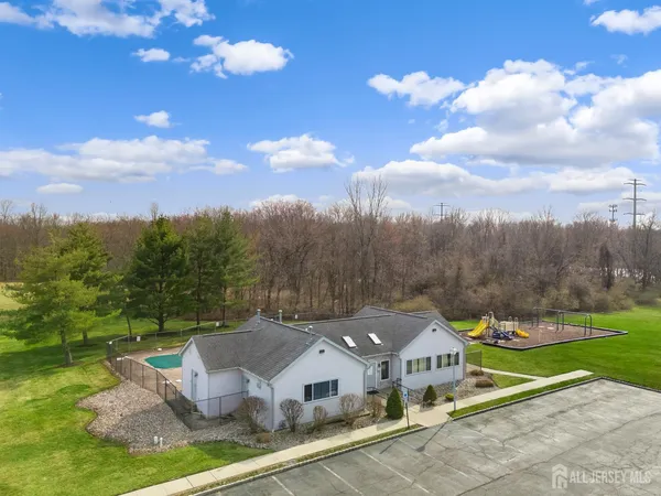 an aerial view of a house with garden space and seating
