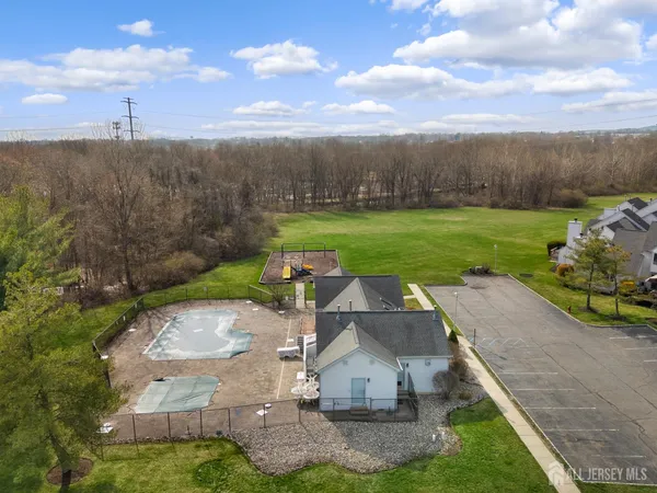 an aerial view of a house with garden space pool seating area and yard