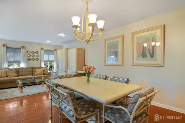 a view of a dining room with furniture wooden floor and chandelier