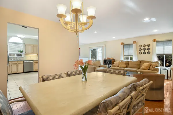 a living room with furniture and a chandelier