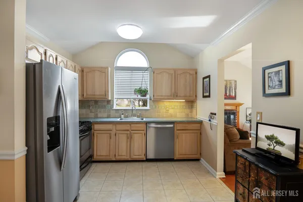a kitchen with a refrigerator and a sink