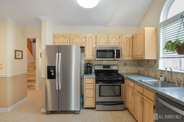 a kitchen with a refrigerator stove and microwave
