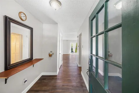 a view of hallway with wooden floor