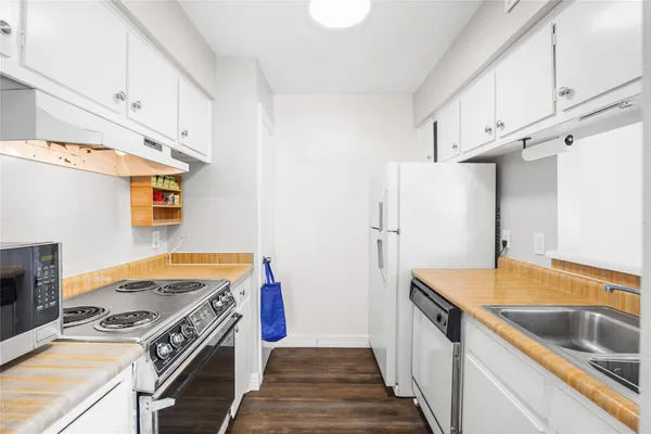 a kitchen with a stove and white cabinets