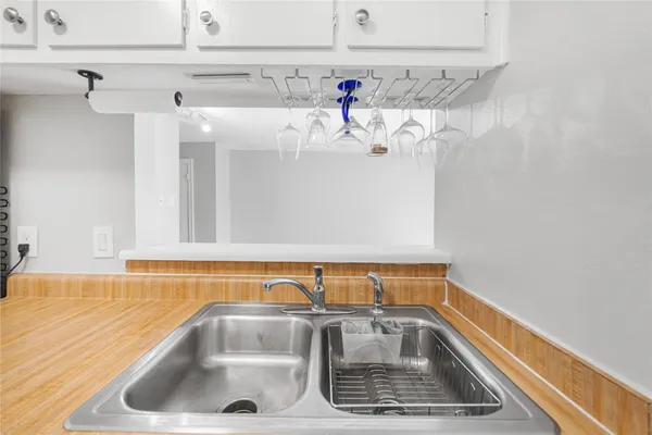 a kitchen with stainless steel appliances granite countertop a sink and a refrigerator