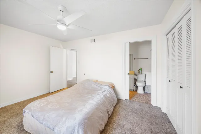 a spacious bedroom with a bed and cabinets