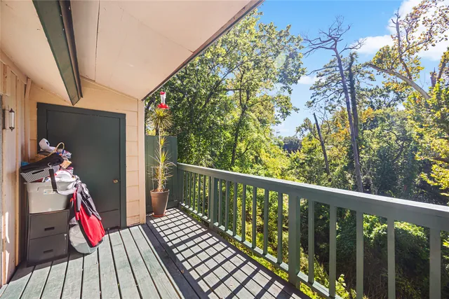 a view of balcony with wooden floor and iron stairs