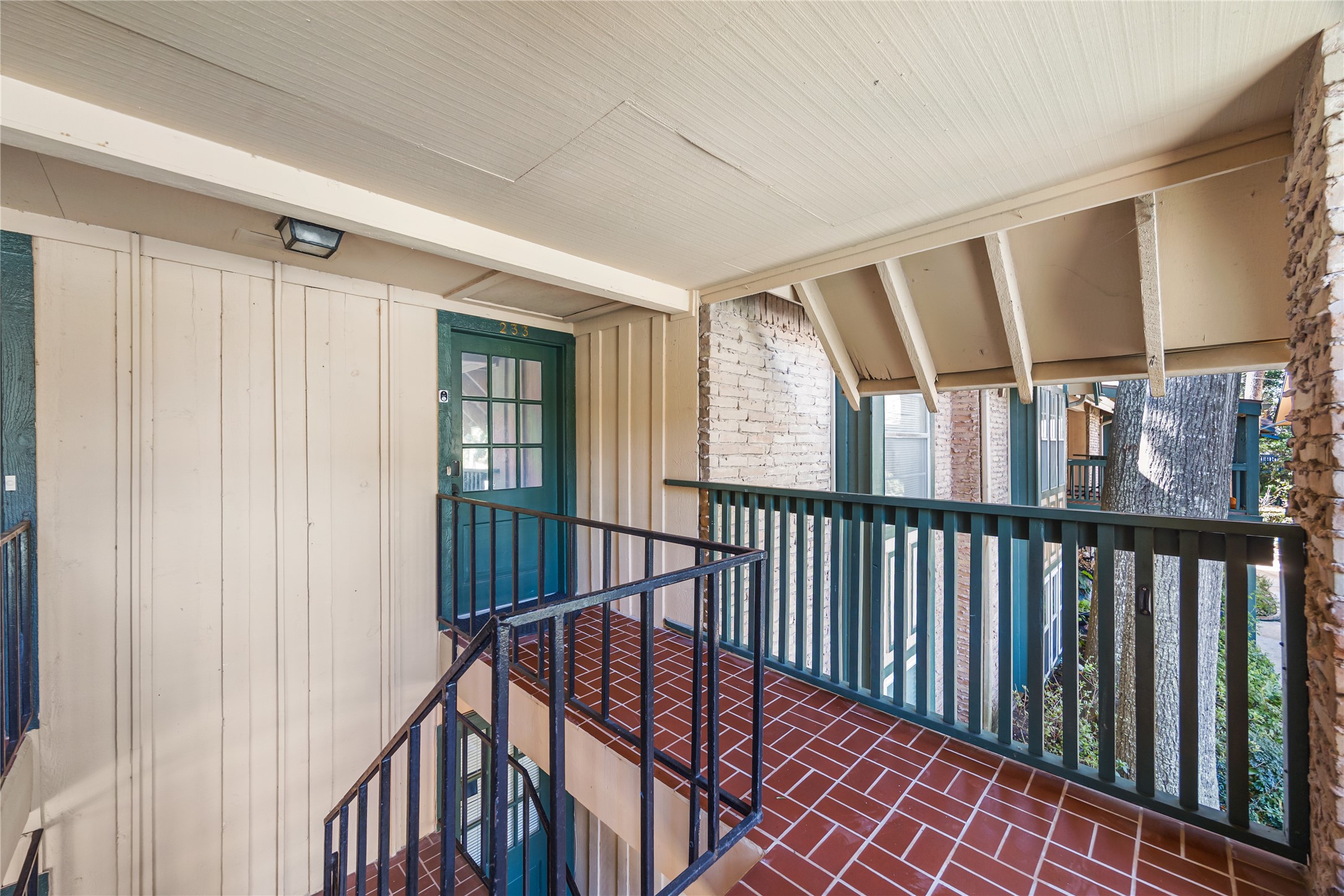 8233 Kingsbrook Road, Unit 233 Houston, TX 77024 - Photo 22 of 24 a view of staircase with lots of frames on wall and a large window