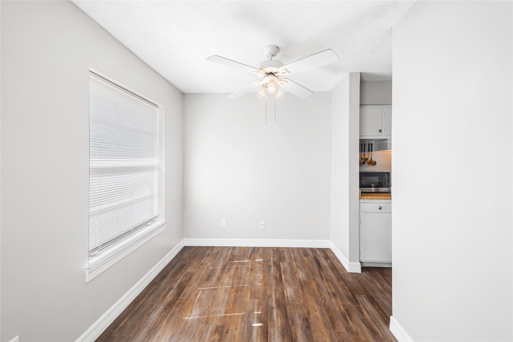 8233 Kingsbrook Road, Unit 233 Houston, TX 77024 - Photo 7 of 24 an empty room with wooden floor closet and windows