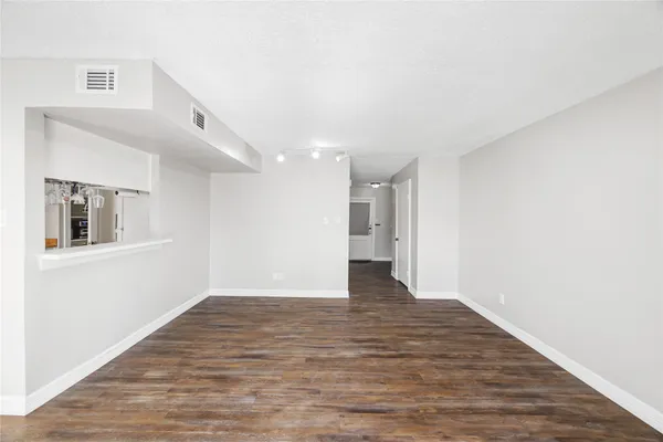 a kitchen with stainless steel appliances granite countertop a sink a stove and refrigerator