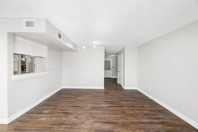 a kitchen with stainless steel appliances granite countertop a sink a stove and refrigerator