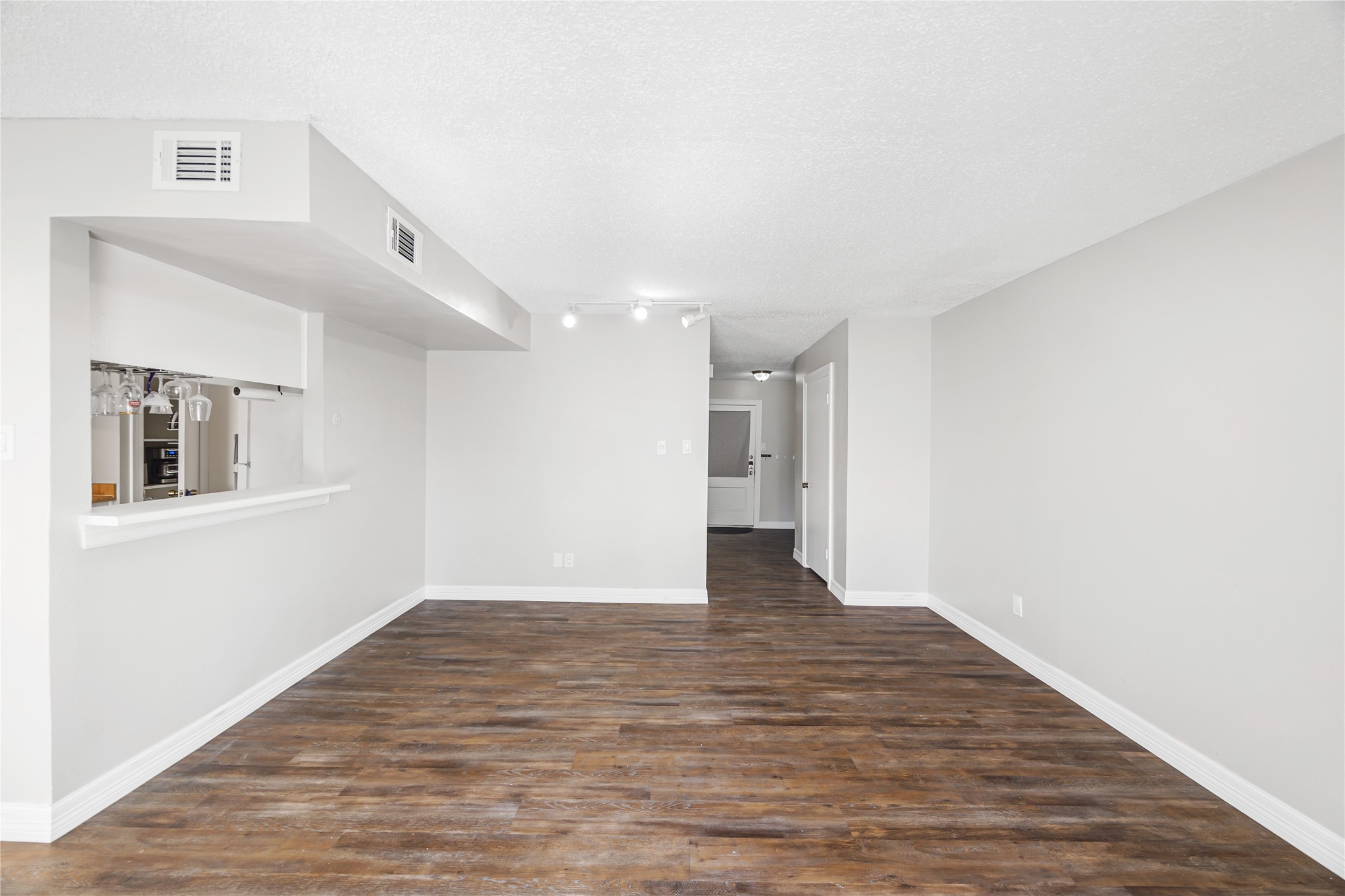 8233 Kingsbrook Road, Unit 233 Houston, TX 77024 - Photo 10 of 24 a view of an empty room with wooden floor and a window