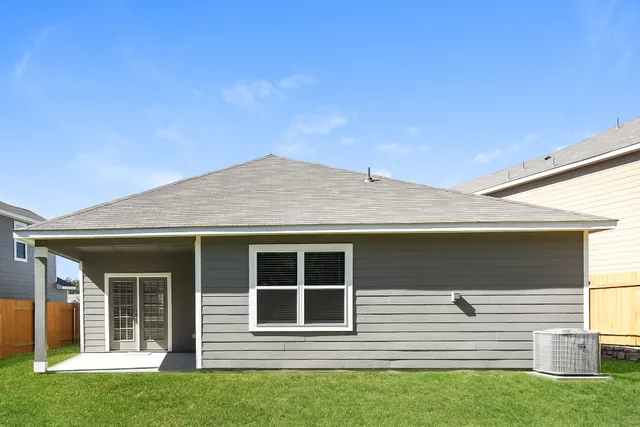 a view of house with backyard