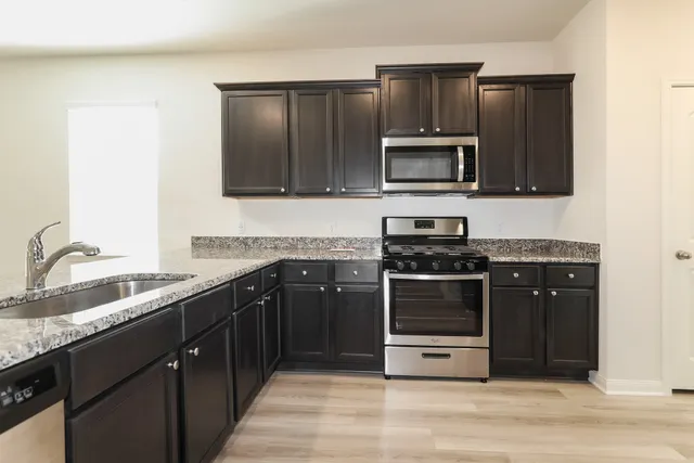 a kitchen with a stove microwave and refrigerator