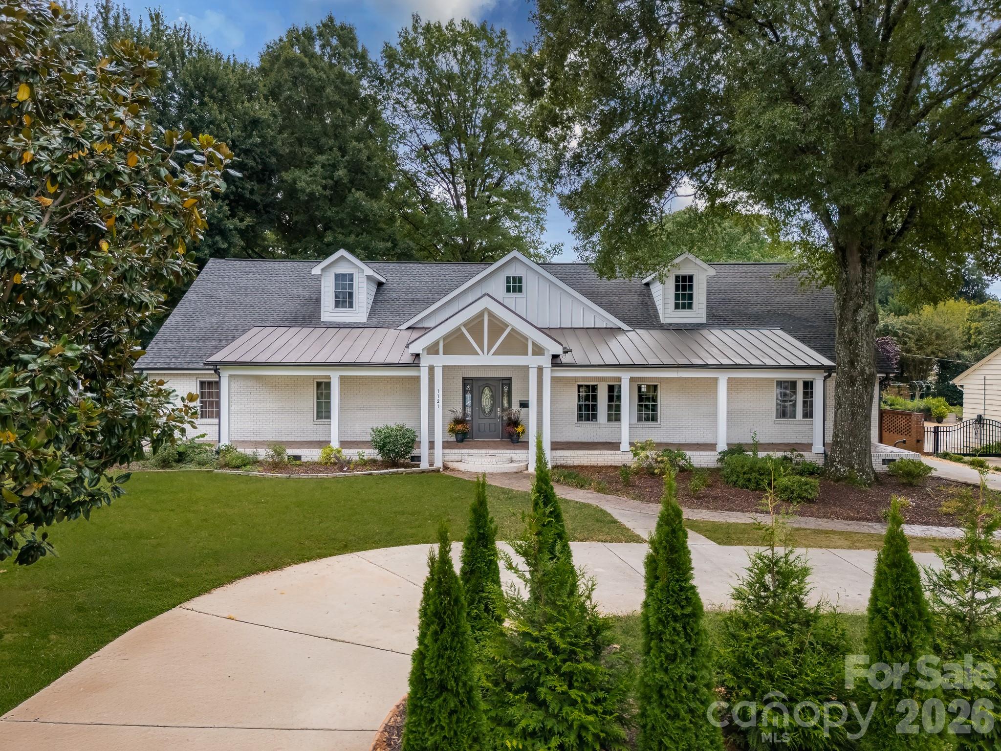 1121 South Wendover Road Charlotte, NC 28211 - Photo 1 of 48 a front view of a house with a yard table and chairs