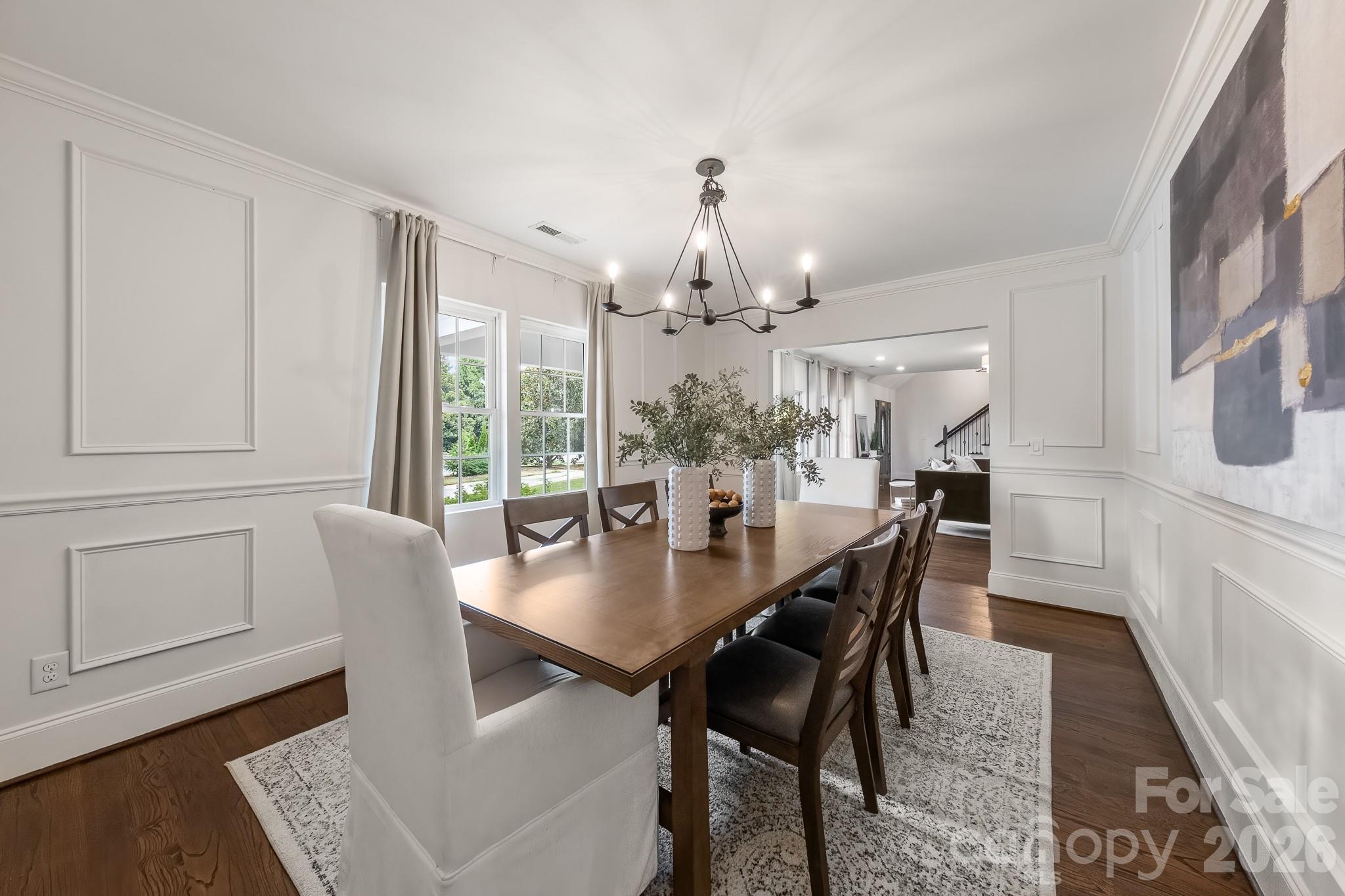 1121 South Wendover Road Charlotte, NC 28211 - Photo 12 of 48 a dining room with furniture a chandelier and wooden floor