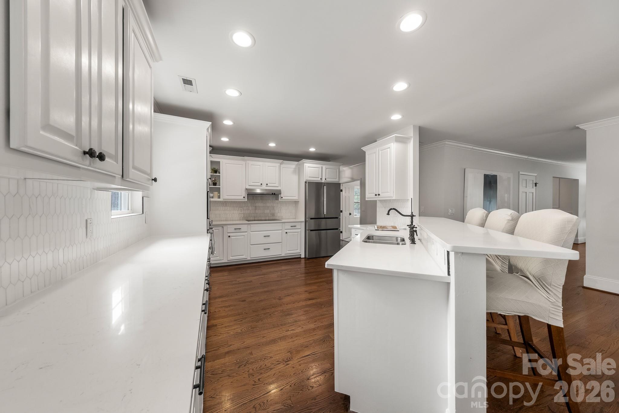 1121 South Wendover Road Charlotte, NC 28211 - Photo 19 of 48 a large white kitchen with a large window and stainless steel appliances