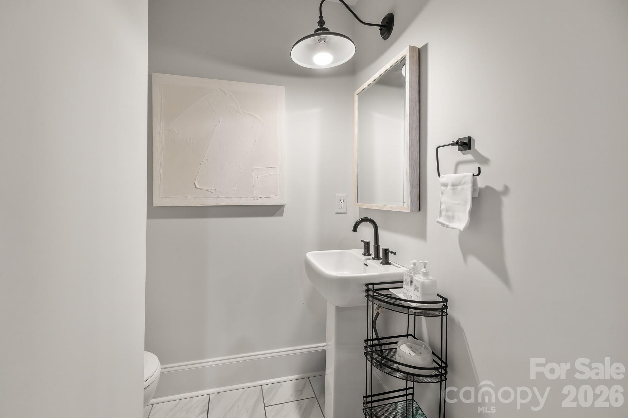 1121 South Wendover Road Charlotte, NC 28211 - Photo 23 of 48 a bathroom with a sink and a mirror