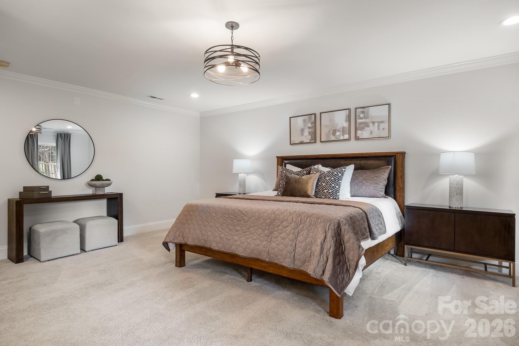 1121 South Wendover Road Charlotte, NC 28211 - Photo 25 of 48 a bedroom with a bed a mirror and lamp on dresser