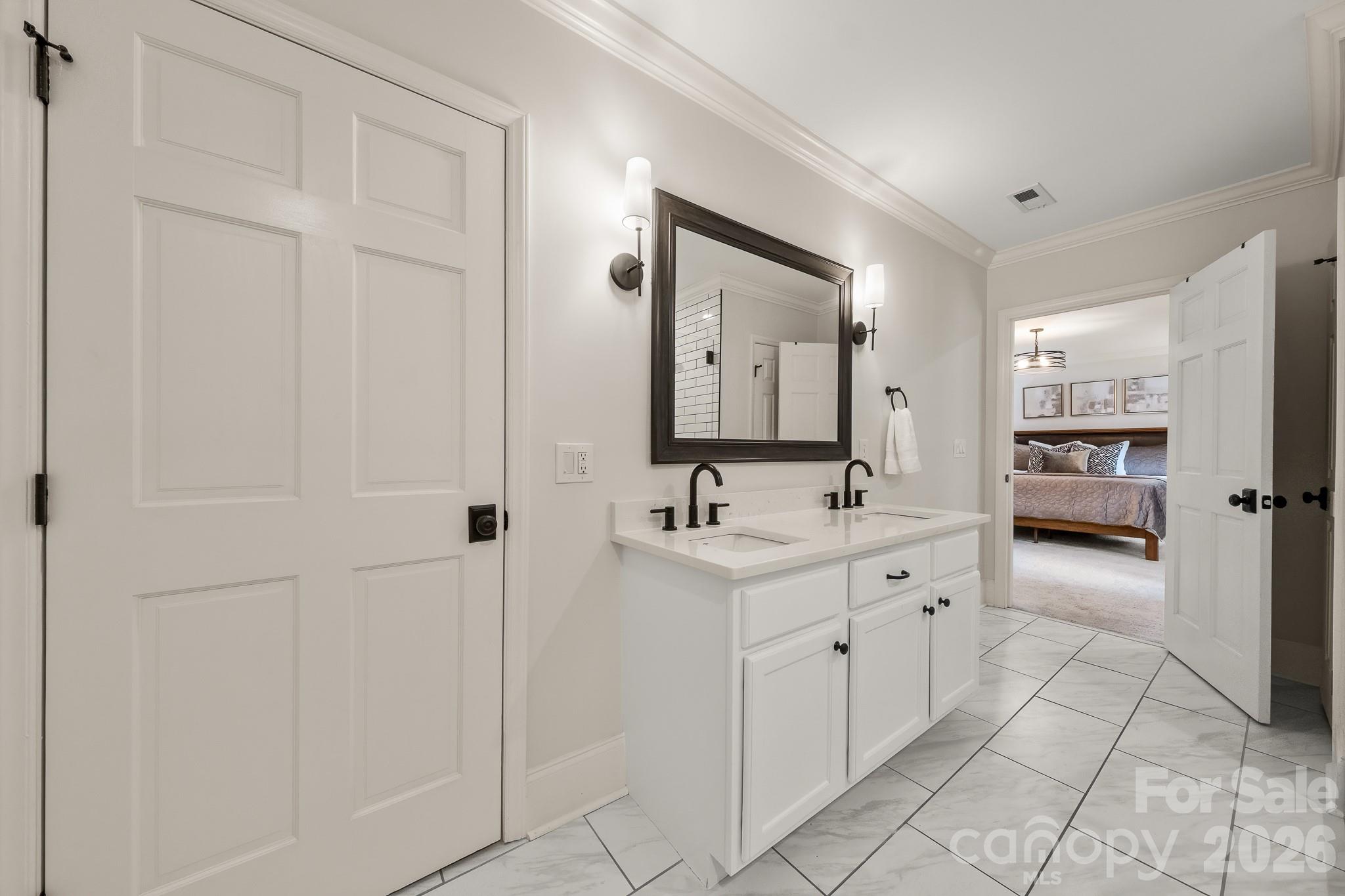 1121 South Wendover Road Charlotte, NC 28211 - Photo 28 of 48 a spacious bathroom with a double vanity sink and a mirror