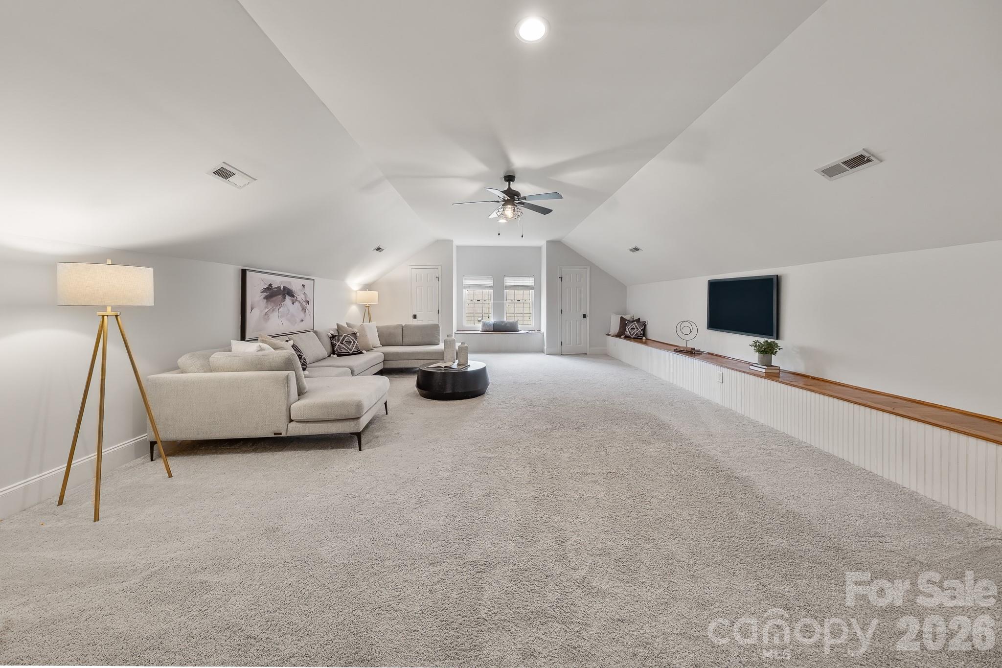 1121 South Wendover Road Charlotte, NC 28211 - Photo 30 of 48 a living room with furniture a flat screen tv and a ceiling fan