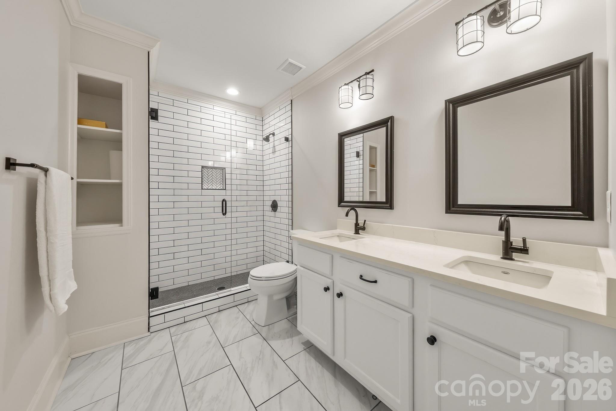 1121 South Wendover Road Charlotte, NC 28211 - Photo 40 of 48 a bathroom with a toilet sink and mirror