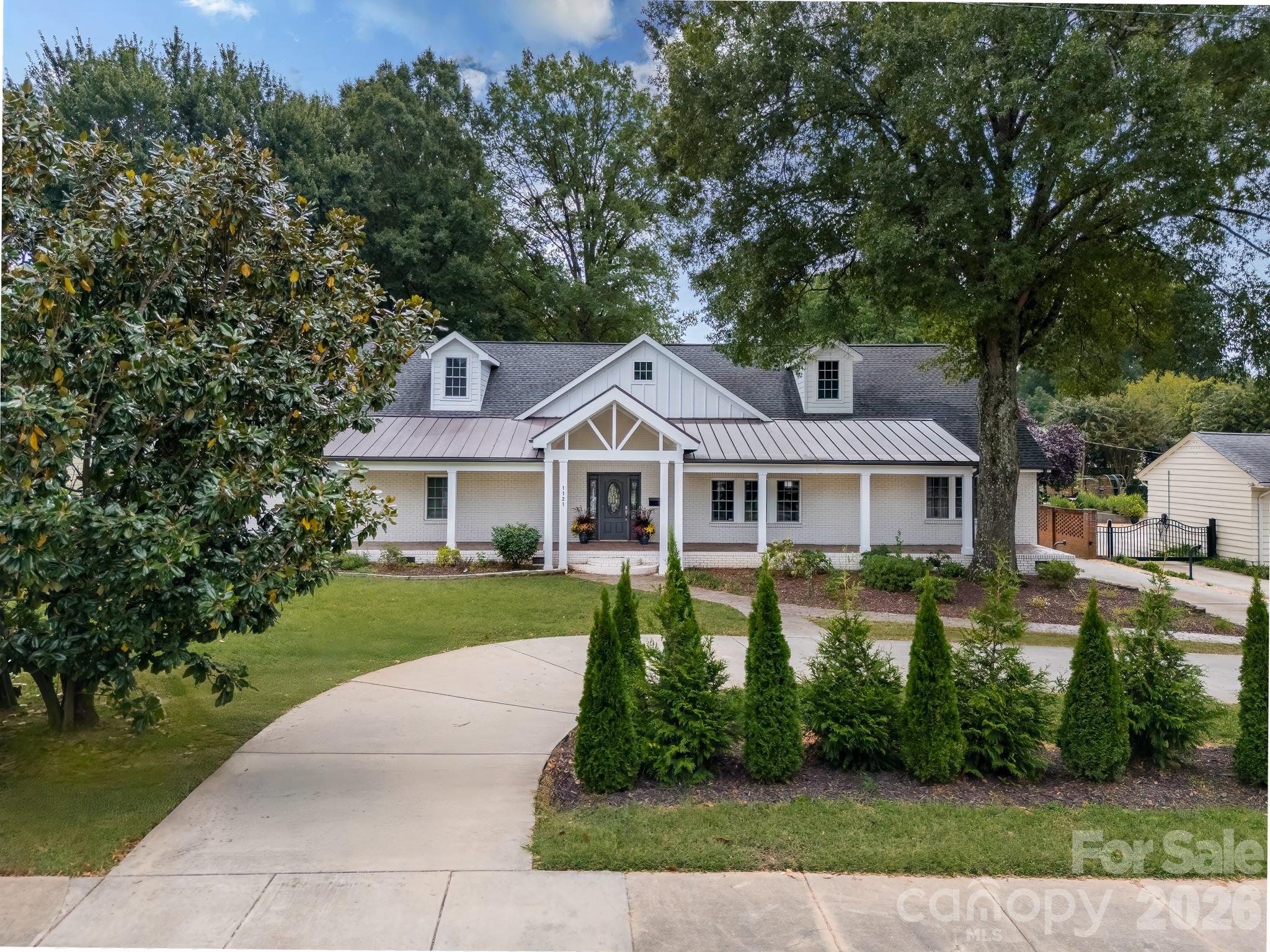 1121 South Wendover Road Charlotte, NC 28211 - Photo 4 of 48 a front view of a house with a yard and large trees