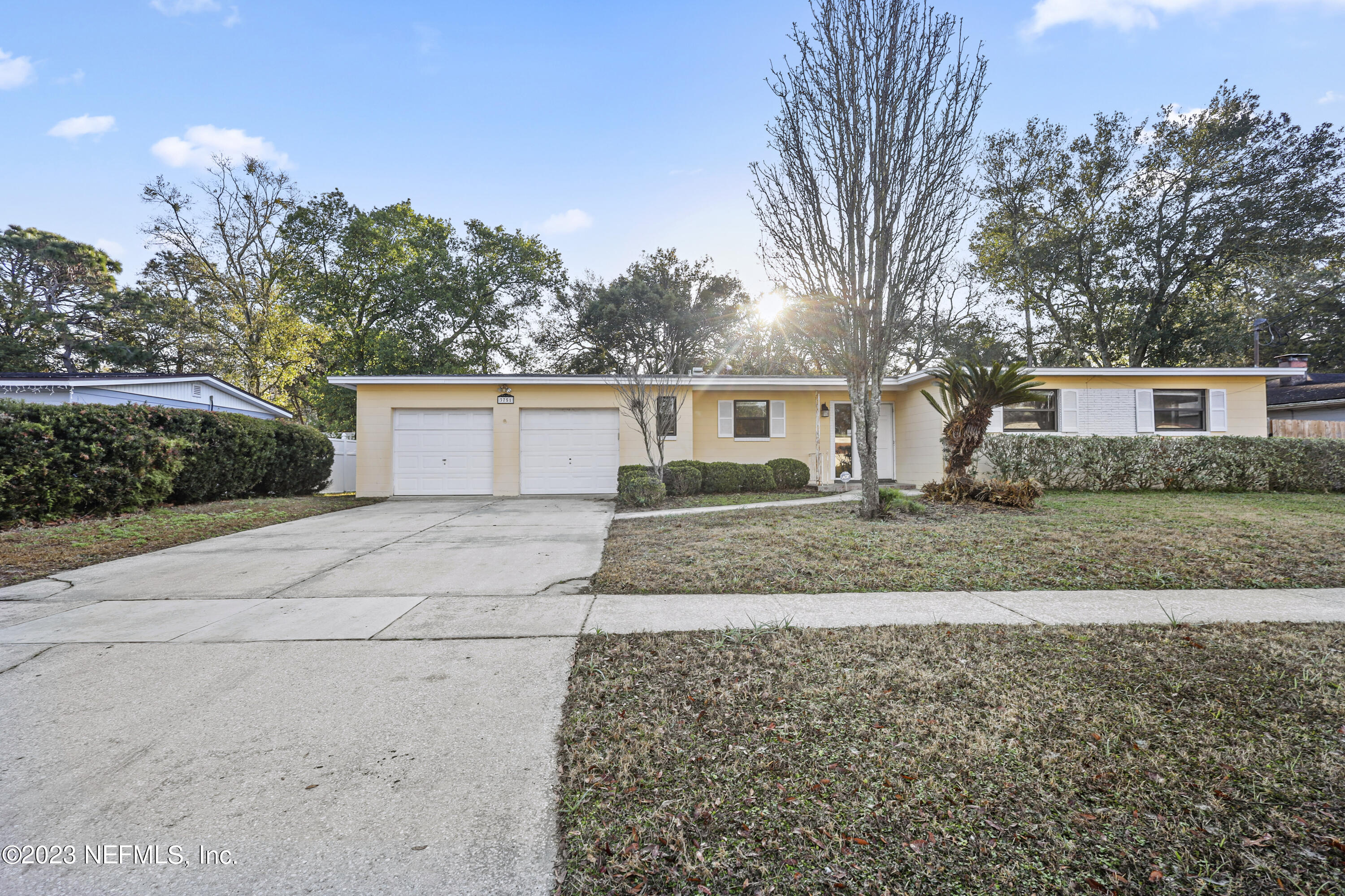 3751 Bess Road Jacksonville, FL 32277 - Photo 1 of 38 a front view of a house with a yard and a garage