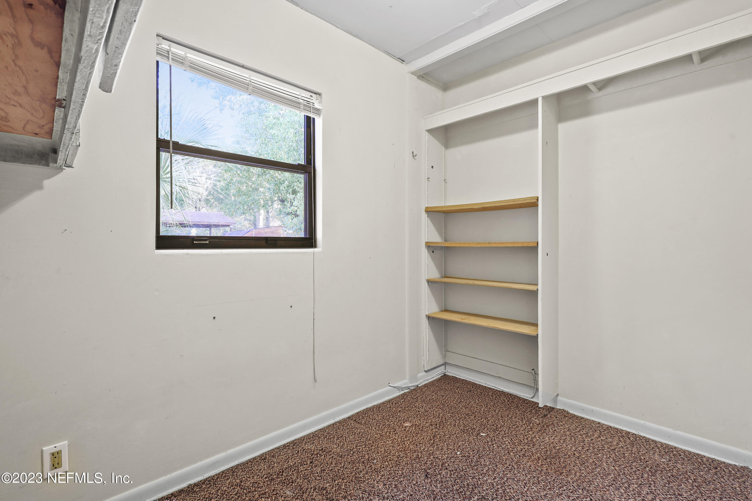 3751 Bess Road Jacksonville, FL 32277 - Photo 18 of 38 a view of an empty room with a window