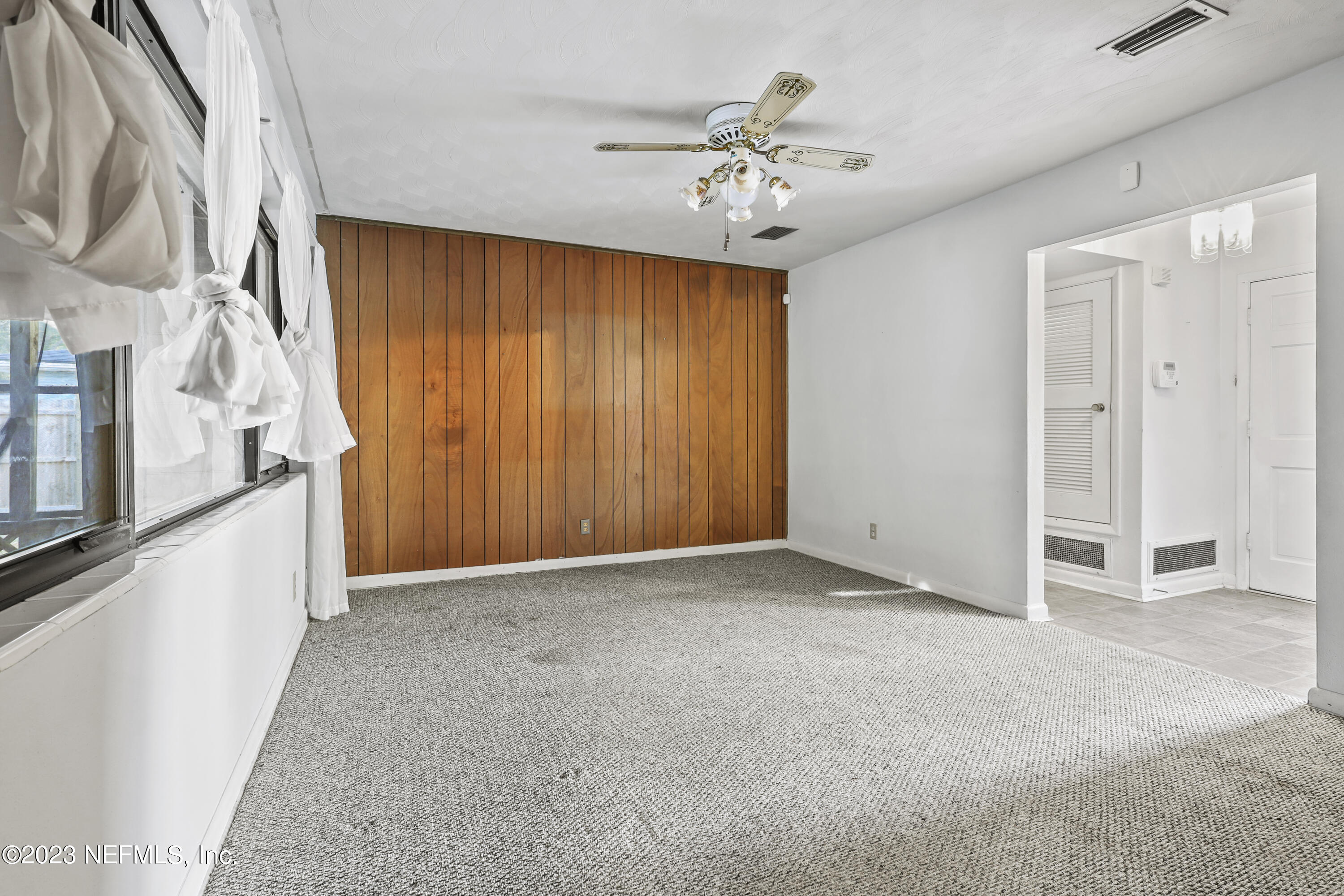 3751 Bess Road Jacksonville, FL 32277 - Photo 9 of 38 a view of an empty room with a chandelier