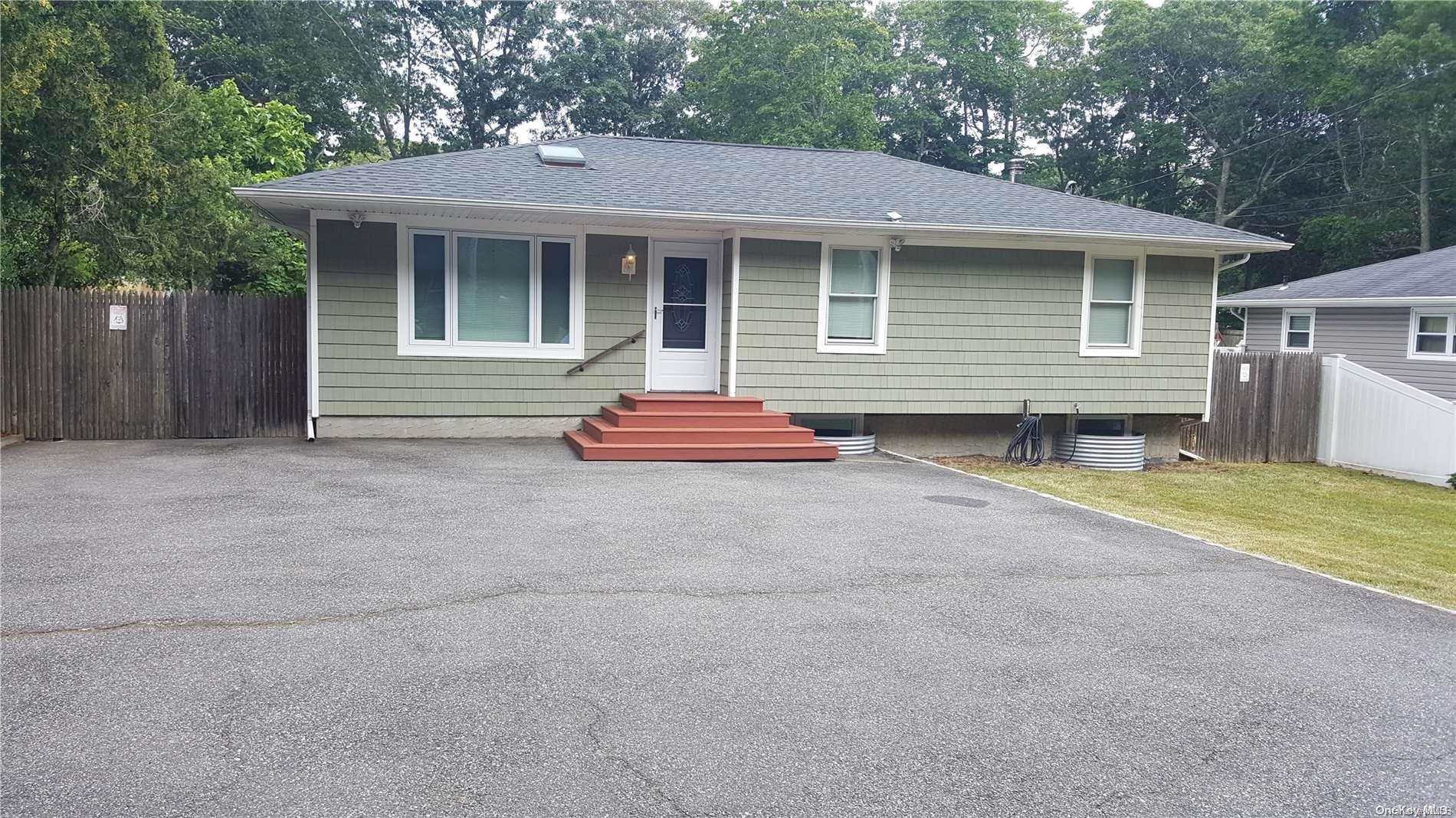 147 Hawthorne Street Mastic, NY 11950 - Photo 1 of 1 a front view of a house with a yard