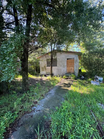 a backyard of a house with yard and outdoor seating