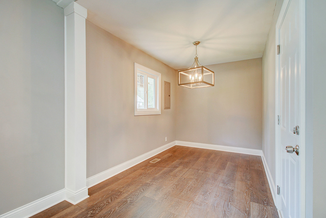 309 Audubon Road Streamwood, IL 60107 - Photo 11 of 25 a view of empty room with wooden floor and windows
