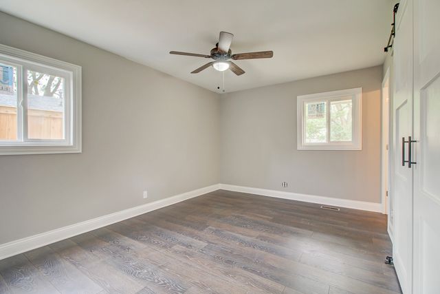 309 Audubon Road Streamwood, IL 60107 - Photo 15 of 25 an empty room with wooden floor ceiling fan and windows