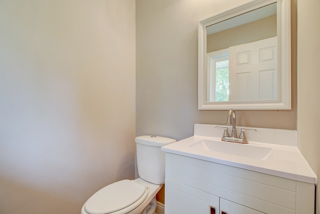 309 Audubon Road Streamwood, IL 60107 - Photo 17 of 25 a bathroom with a sink a toilet and a mirror