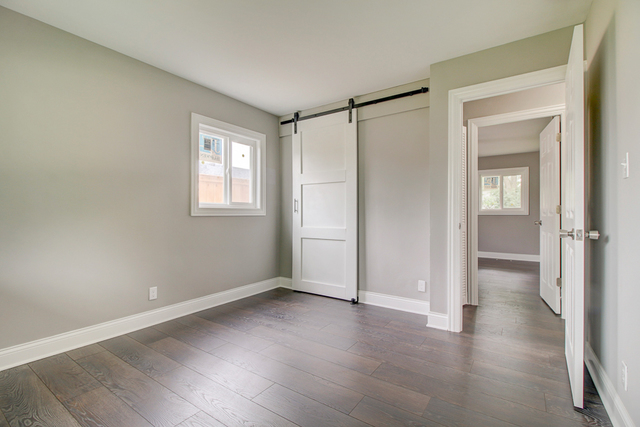 309 Audubon Road Streamwood, IL 60107 - Photo 19 of 25 a view of an empty room with wooden floor and a window