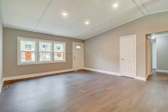 309 Audubon Road Streamwood, IL 60107 - Photo 4 of 25 an empty room with wooden floor and windows