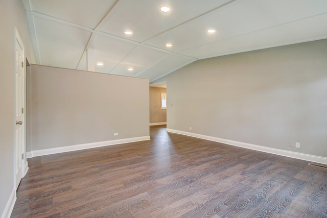 309 Audubon Road Streamwood, IL 60107 - Photo 6 of 25 a view of an empty room with wooden floor