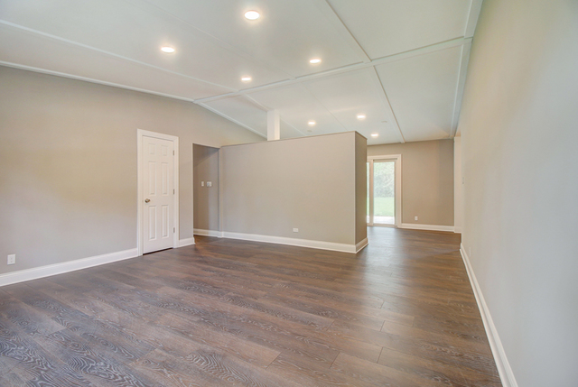 309 Audubon Road Streamwood, IL 60107 - Photo 7 of 25 an empty room with wooden floor and windows