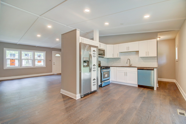 309 Audubon Road Streamwood, IL 60107 - Photo 8 of 25 a kitchen with stainless steel appliances a refrigerator and a stove top oven