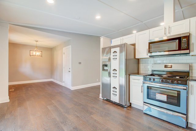 309 Audubon Road Streamwood, IL 60107 - Photo 9 of 25 a kitchen with stainless steel appliances a stove a microwave and a refrigerator