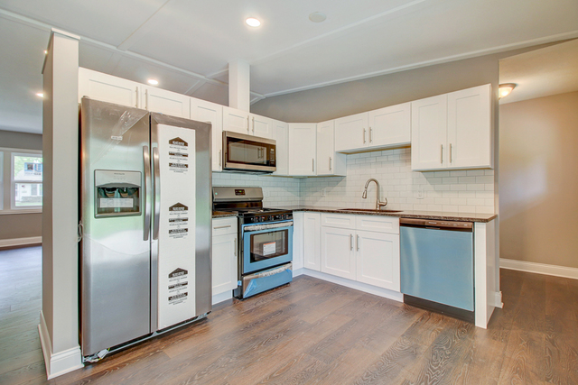 309 Audubon Road Streamwood, IL 60107 - Photo 10 of 25 a kitchen with granite countertop a refrigerator and a stove top oven