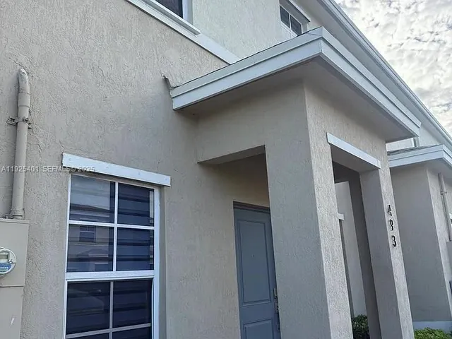 a bedroom with a bed and cabinets