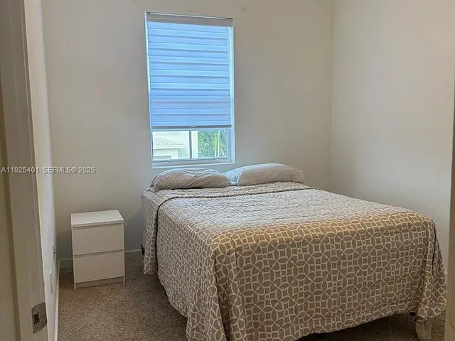 a view of a backyard with wooden fence